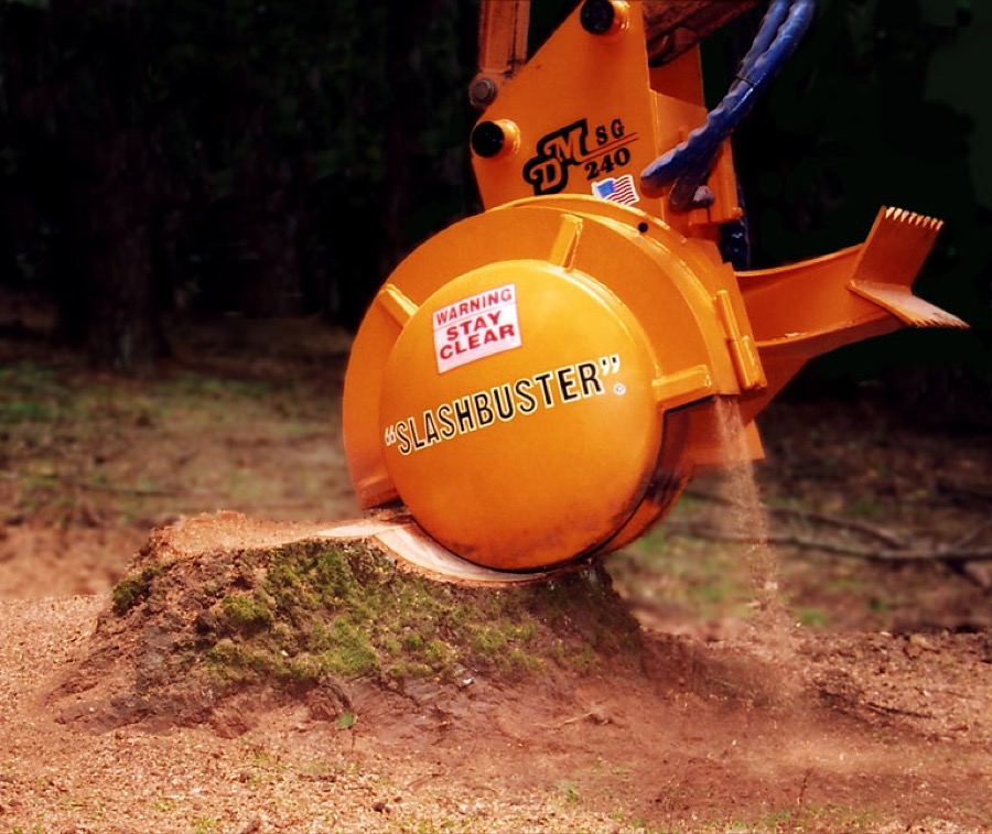 Close reference view of a stump-grinding machine at work.